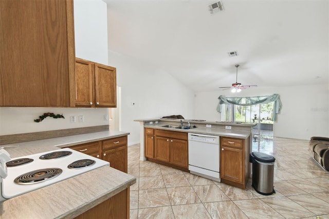 kitchen with light countertops, brown cabinetry, open floor plan, white dishwasher, and a sink