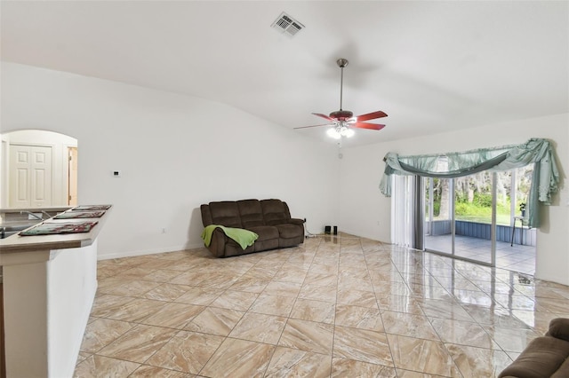 living area with arched walkways, marble finish floor, ceiling fan, and visible vents