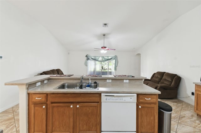 kitchen featuring brown cabinetry, dishwasher, open floor plan, light countertops, and a sink