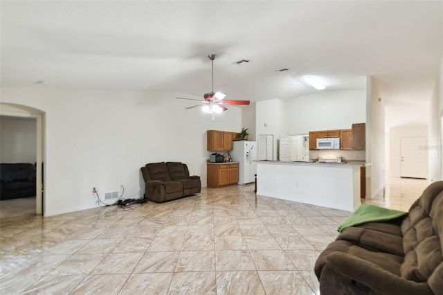 living room featuring lofted ceiling, ceiling fan, arched walkways, and visible vents