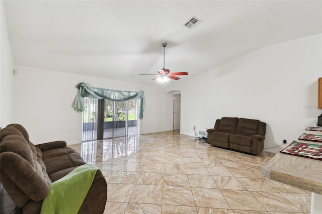 living area with arched walkways, marble finish floor, visible vents, a ceiling fan, and vaulted ceiling