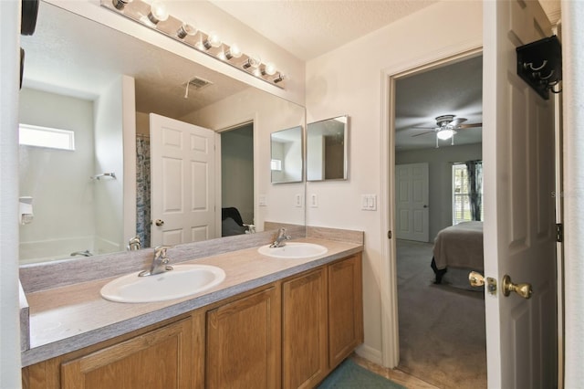 bathroom featuring connected bathroom, a sink, and double vanity