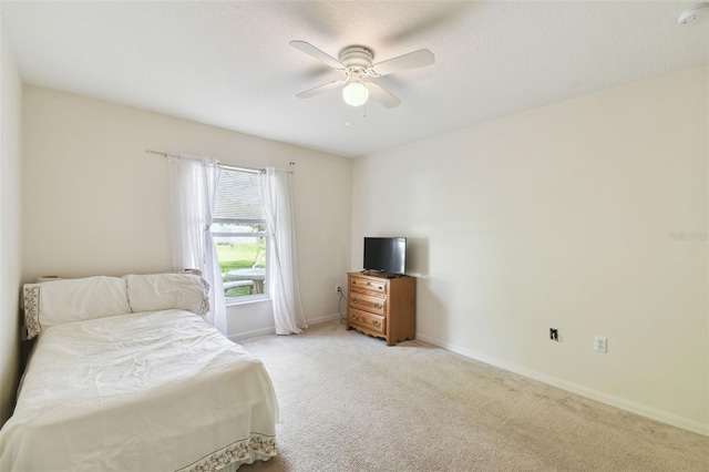 bedroom with baseboards, ceiling fan, and light colored carpet