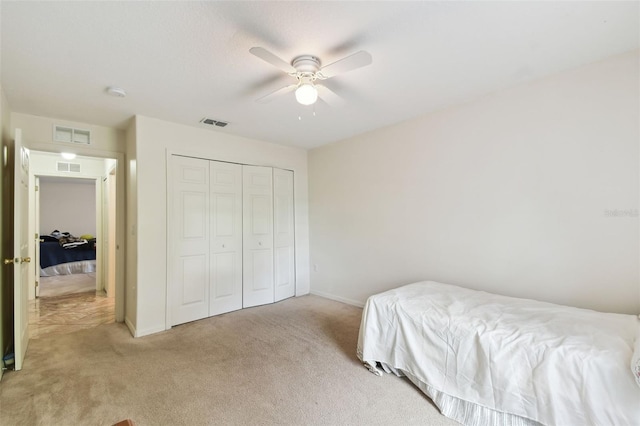 bedroom featuring visible vents and light colored carpet