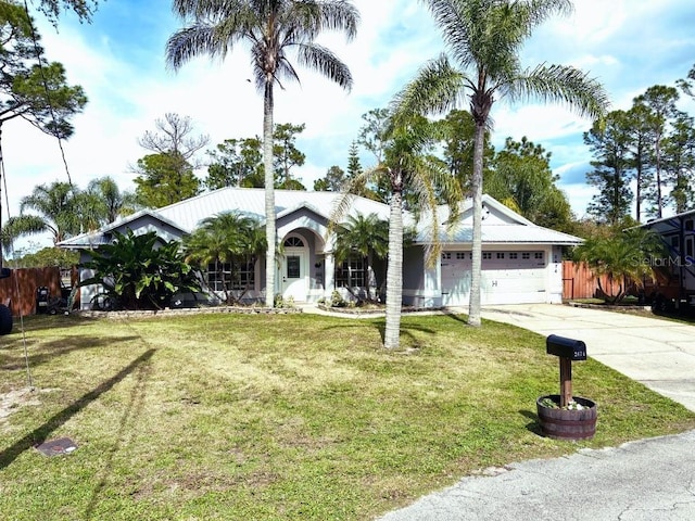 ranch-style house with a garage, a front yard, concrete driveway, and fence