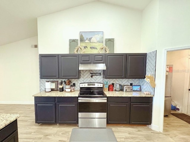 kitchen with electric range, visible vents, under cabinet range hood, high vaulted ceiling, and backsplash