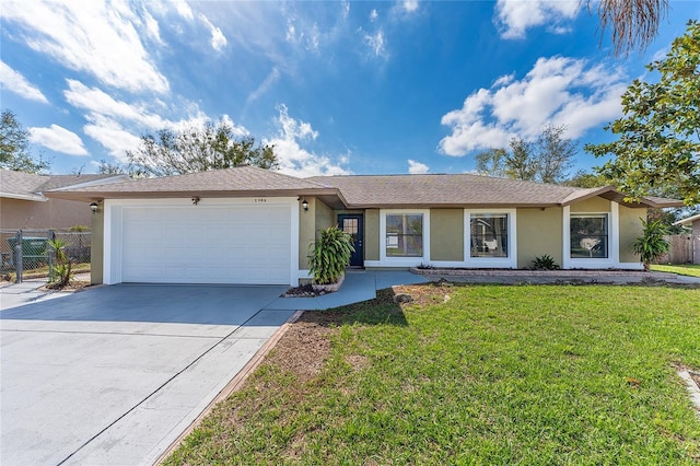 ranch-style home with a garage, concrete driveway, a front lawn, and stucco siding