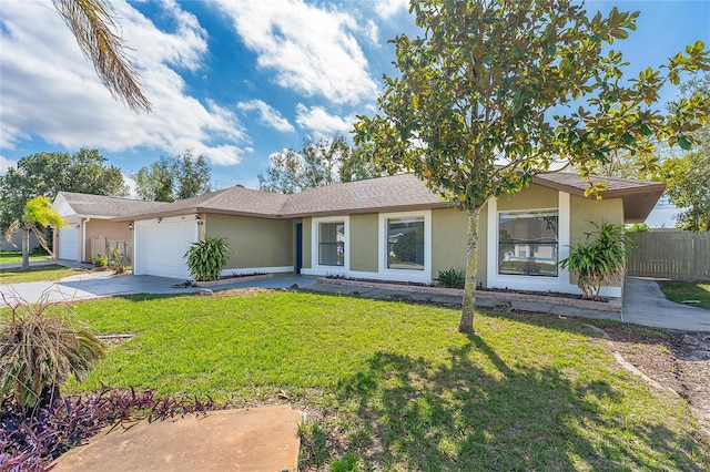 single story home featuring concrete driveway, a front yard, an attached garage, and stucco siding