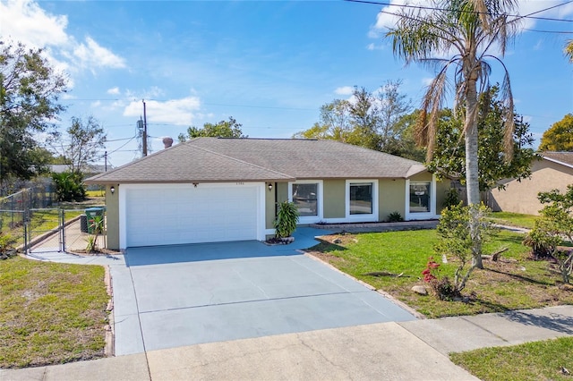 single story home featuring an attached garage, stucco siding, concrete driveway, and a front yard