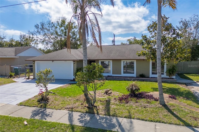 single story home featuring a garage, concrete driveway, a front lawn, and stucco siding