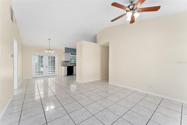 spare room with french doors, light tile patterned floors, visible vents, vaulted ceiling, and ceiling fan with notable chandelier