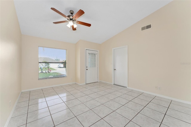 empty room with lofted ceiling, ceiling fan, visible vents, and baseboards