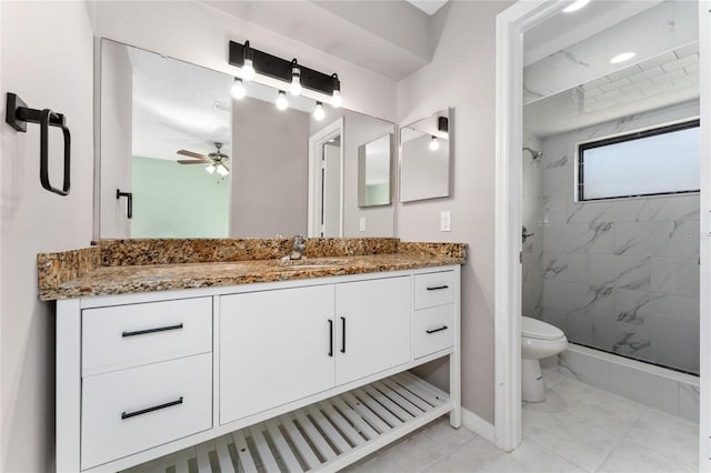 full bath featuring a marble finish shower, baseboards, toilet, ceiling fan, and vanity