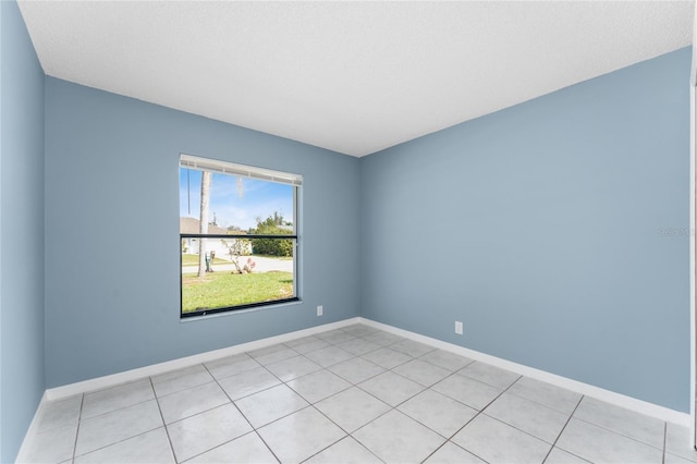 unfurnished room featuring baseboards