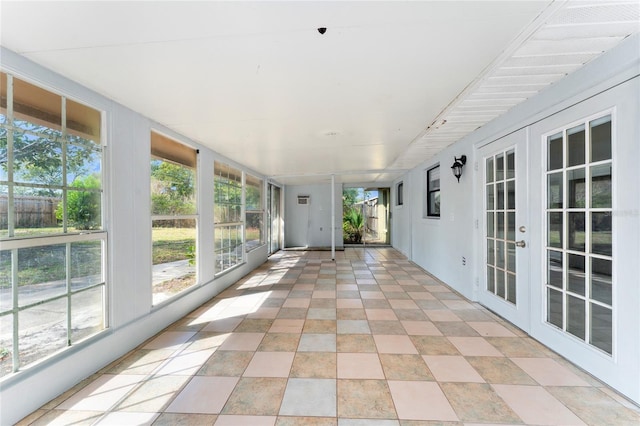 unfurnished sunroom featuring a healthy amount of sunlight and french doors