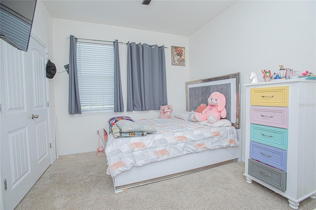 bedroom featuring light carpet, ceiling fan, and baseboards