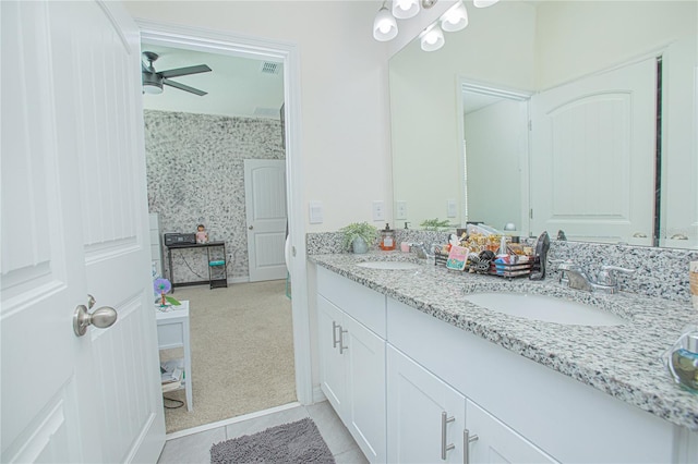 full bathroom featuring double vanity, a ceiling fan, visible vents, and a sink