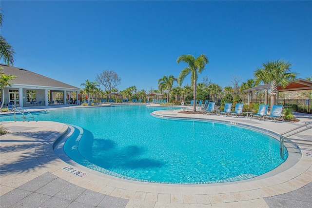 pool with a gazebo, a patio area, and fence