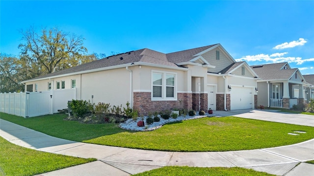 view of front of house with concrete driveway, a gate, fence, a front lawn, and stucco siding