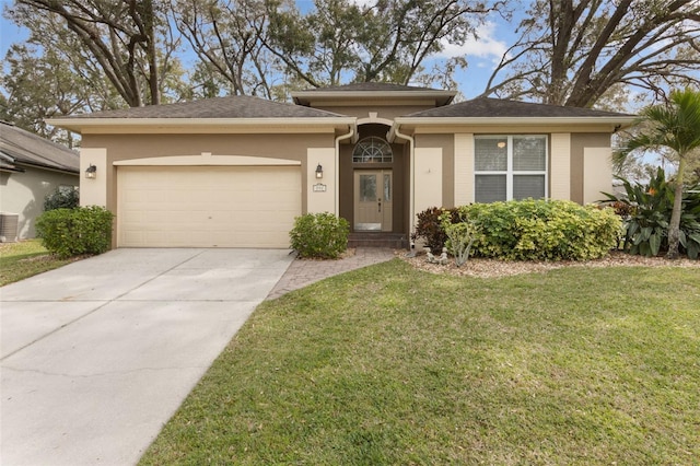 view of front of home with an attached garage, central AC, concrete driveway, stucco siding, and a front lawn