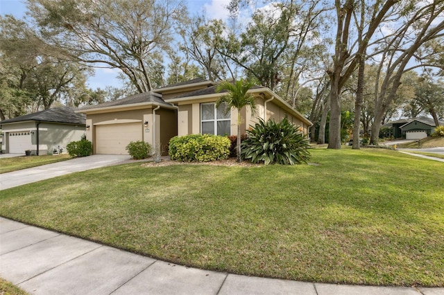 view of front of property with driveway, an attached garage, a front yard, and stucco siding