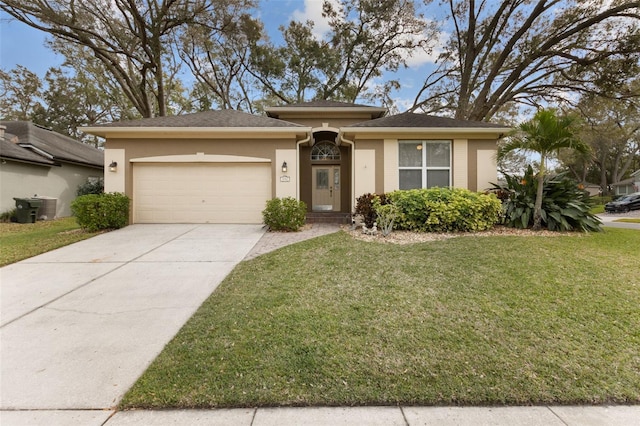 view of front of house with an attached garage, brick siding, driveway, and a front yard