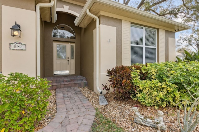 doorway to property with stucco siding