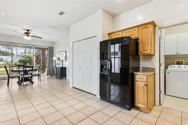 kitchen with washer / dryer, light tile patterned floors, visible vents, black refrigerator with ice dispenser, and light countertops