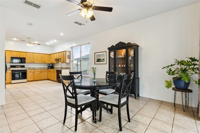 dining room featuring visible vents, ceiling fan, baseboards, and light tile patterned flooring