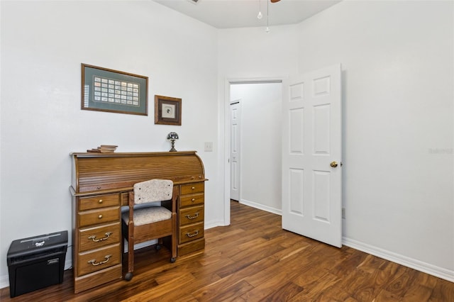 office area featuring dark wood-style floors, a ceiling fan, and baseboards