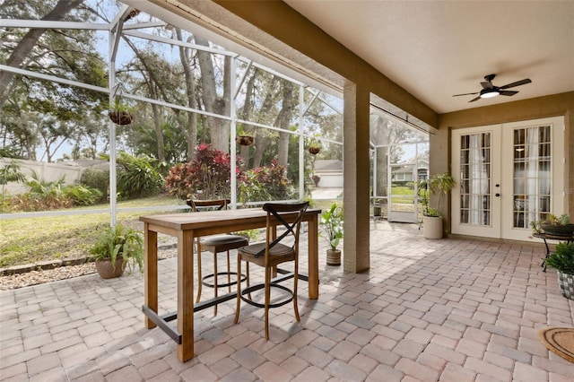 sunroom / solarium featuring ceiling fan and french doors