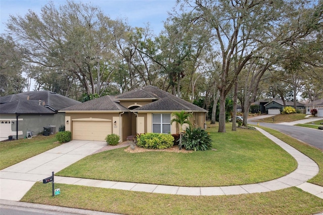 view of front of home with concrete driveway, a front lawn, and stucco siding