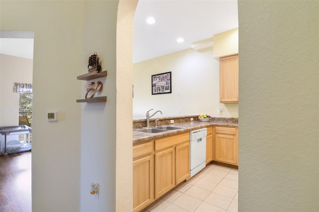 kitchen with light tile patterned floors, open shelves, light brown cabinetry, white dishwasher, and a sink