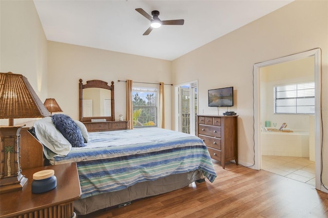 bedroom featuring light wood-style floors, ceiling fan, and ensuite bathroom