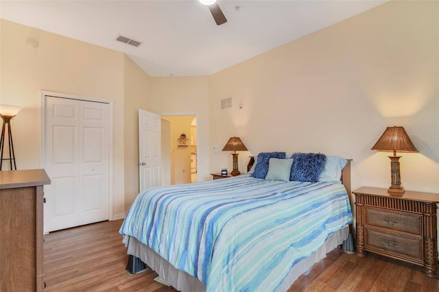 bedroom featuring a ceiling fan, a closet, visible vents, and wood finished floors