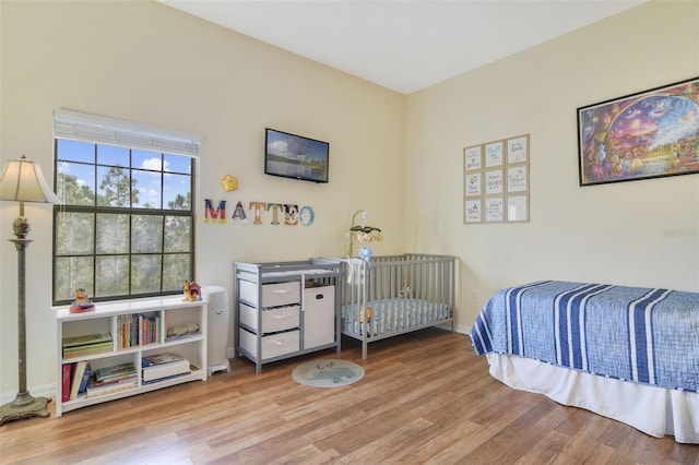 bedroom with baseboards and wood finished floors