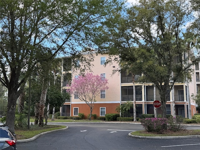 view of building exterior featuring uncovered parking