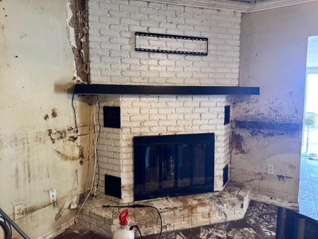 room details featuring a brick fireplace and crown molding