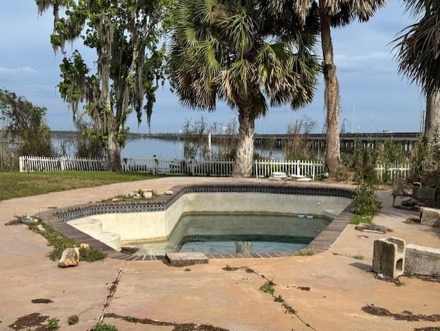 view of pool featuring fence, a patio, and an in ground hot tub