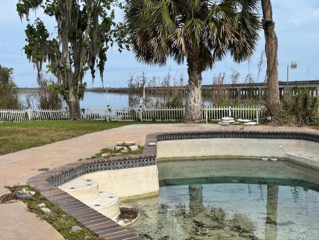 view of home's community with fence and a pool