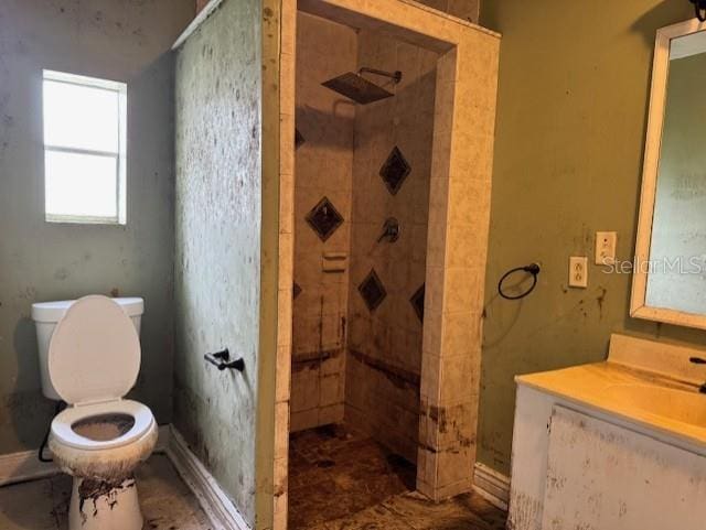 full bathroom with a shower stall, toilet, and vanity