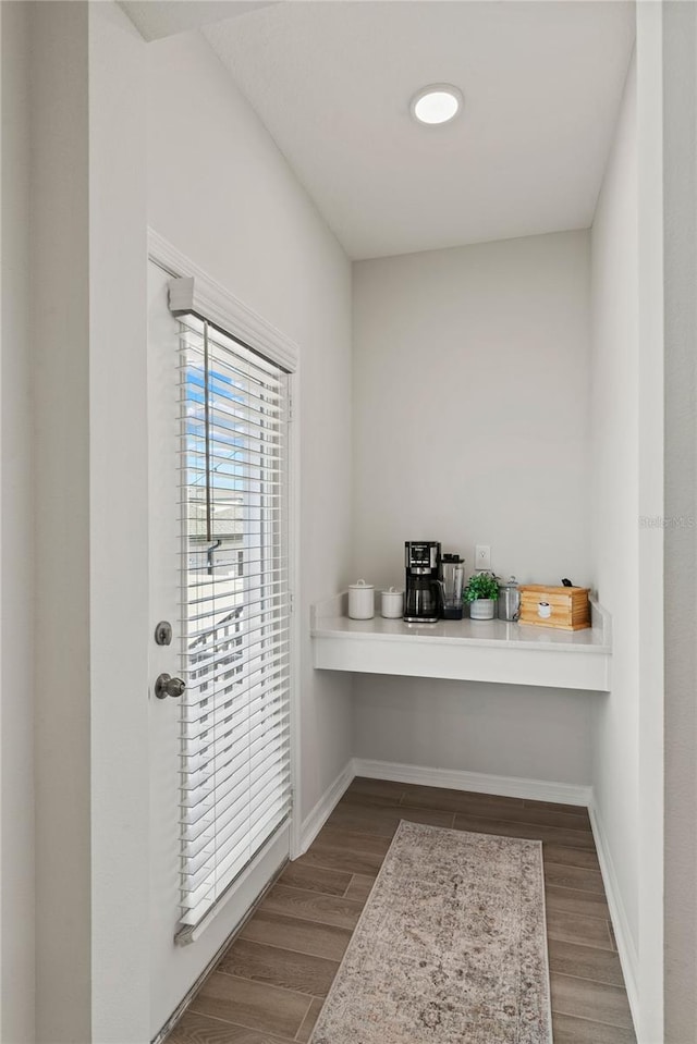 office area with dark wood finished floors and baseboards