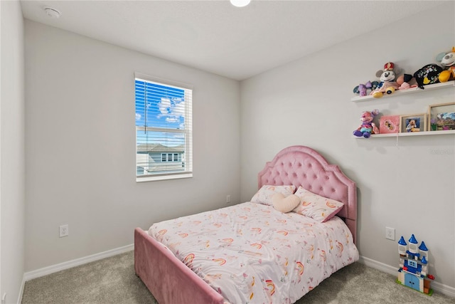 carpeted bedroom featuring baseboards