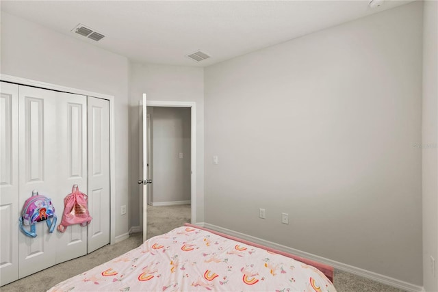 bedroom featuring baseboards, visible vents, a closet, and light colored carpet