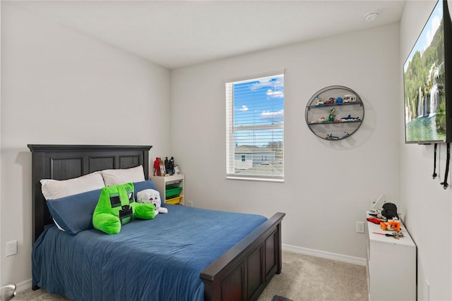 bedroom featuring baseboards and light colored carpet