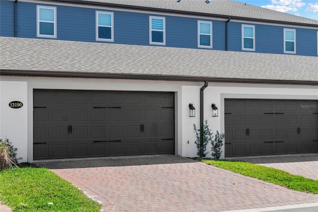 garage with decorative driveway