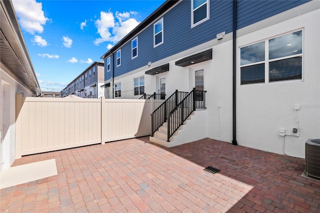 view of patio / terrace featuring central air condition unit and fence