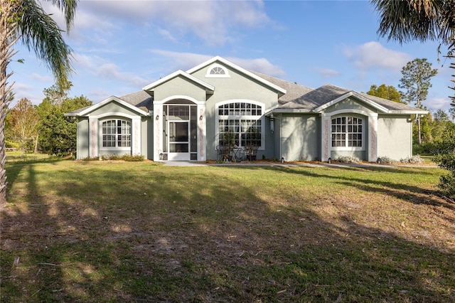 ranch-style house with a front lawn and stucco siding