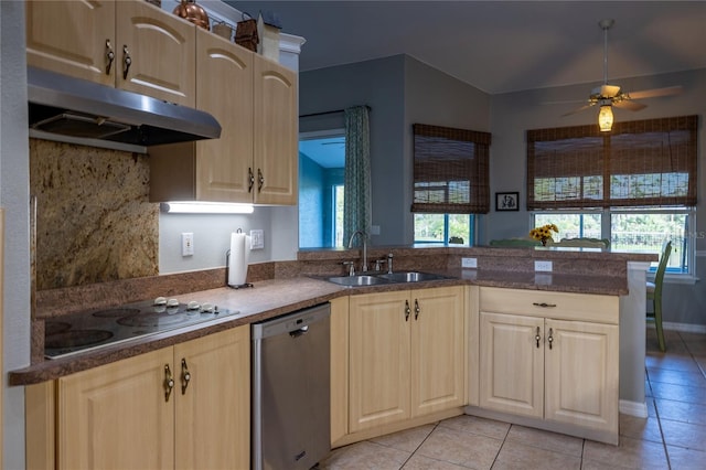 kitchen featuring under cabinet range hood, a peninsula, a sink, stainless steel dishwasher, and cooktop