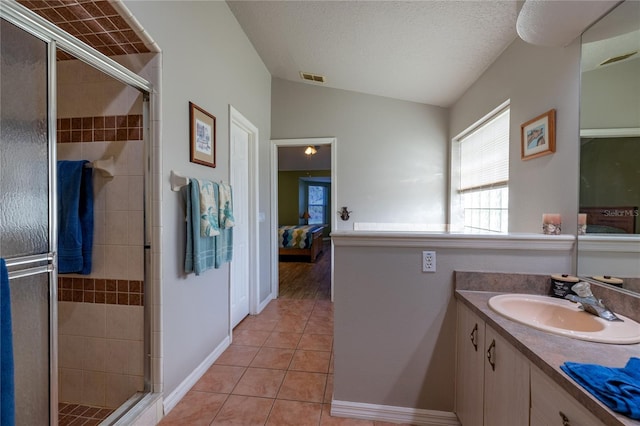 ensuite bathroom featuring visible vents, lofted ceiling, ensuite bathroom, tile patterned floors, and vanity